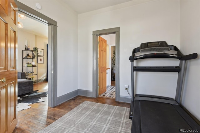 workout area featuring wood finished floors and baseboards