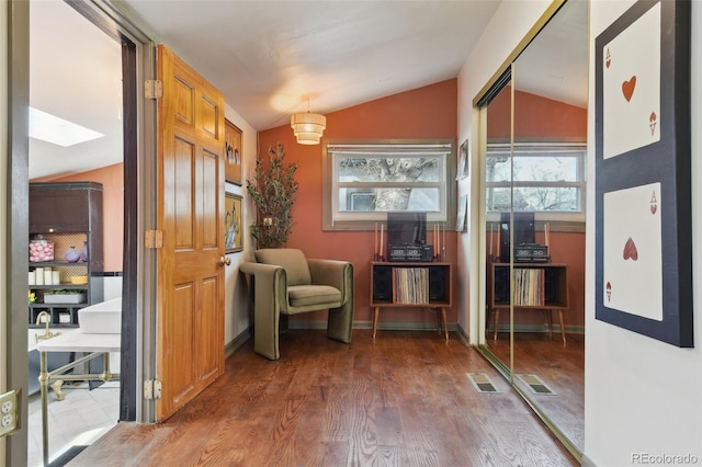 interior space with visible vents, wood finished floors, and vaulted ceiling