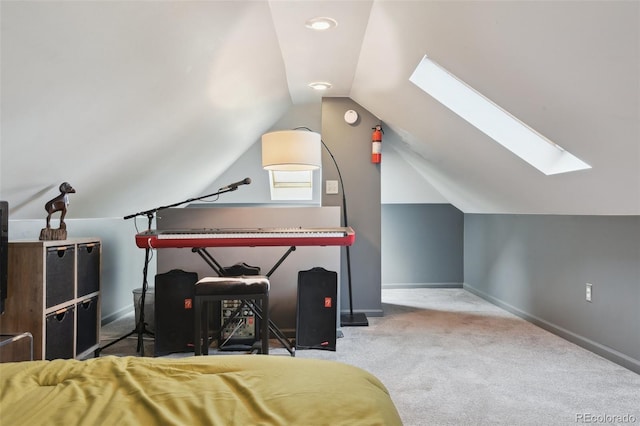 carpeted bedroom with lofted ceiling with skylight and baseboards