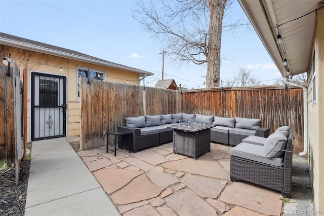 view of patio / terrace with an outdoor living space and a fenced backyard