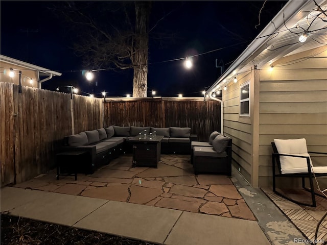 patio at twilight featuring an outdoor hangout area and a fenced backyard