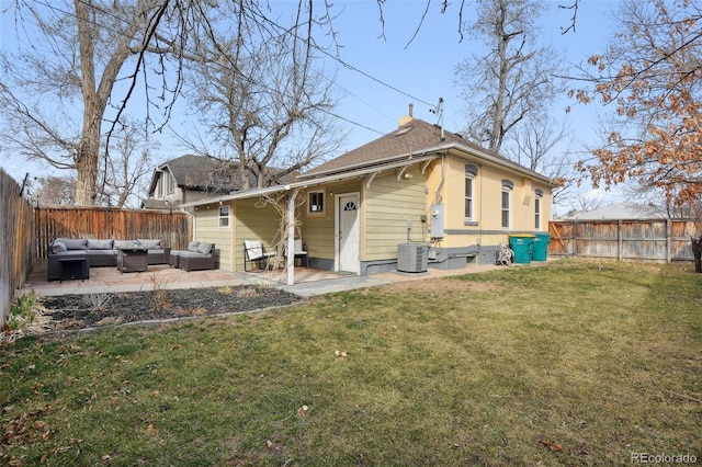 rear view of house featuring a fenced backyard, an outdoor living space, a lawn, and a patio