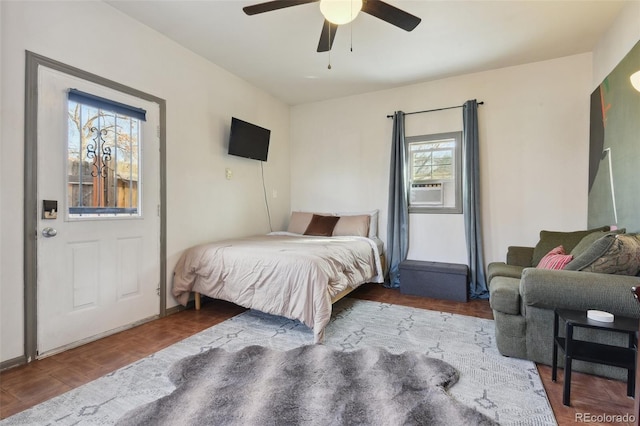 bedroom with cooling unit and ceiling fan