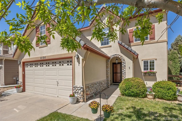 4194 Beautiful Cir, Castle Rock, CO 80109 - view of front facade featuring stone siding, driveway, and stucco siding