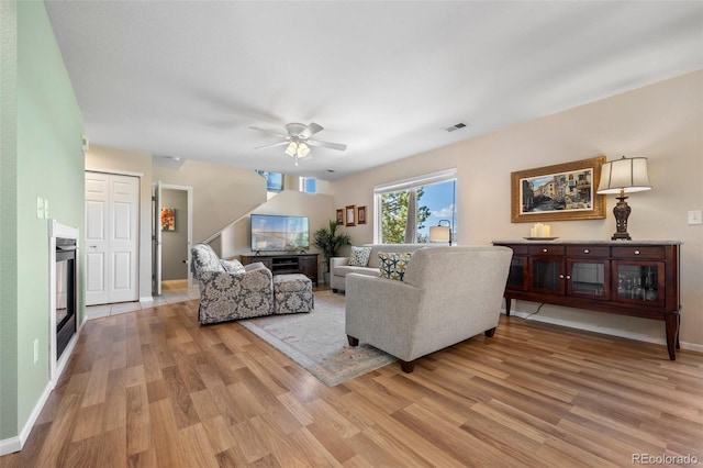 4194 Beautiful Cir, Castle Rock, CO 80109 - living room featuring light wood-style flooring, ceiling fan, and baseboards