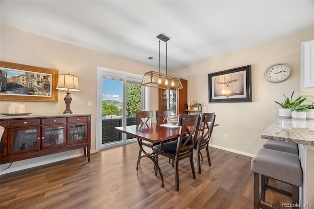 4194 Beautiful Cir, Castle Rock, CO 80109 - dining room featuring dark wood-style flooring and baseboards