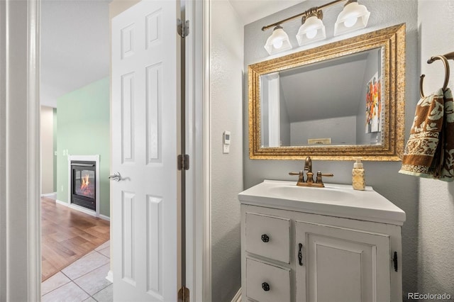 4194 Beautiful Cir, Castle Rock, CO 80109 - bathroom with tile patterned floors, vanity, and a glass covered fireplace