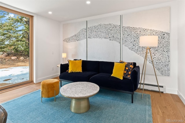 living room featuring floor to ceiling windows, hardwood / wood-style floors, and a baseboard radiator