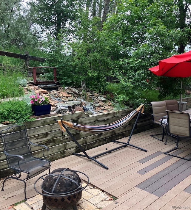 6868 Johnson St, Arvada, CO 80004 - wooden terrace featuring a fire pit