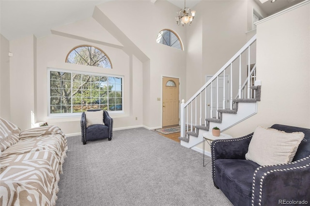 6868 Johnson St, Arvada, CO 80004 - foyer featuring carpet floors, baseboards, stairs, high vaulted ceiling, and a chandelier