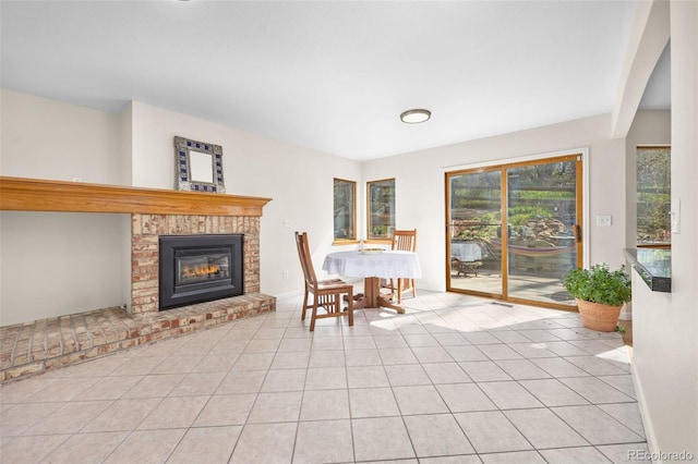 6868 Johnson St, Arvada, CO 80004 - dining space with a brick fireplace, tile patterned floors, and baseboards