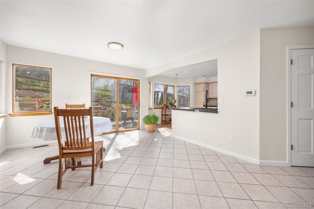 6868 Johnson St, Arvada, CO 80004 - dining room featuring light tile patterned floors and baseboards