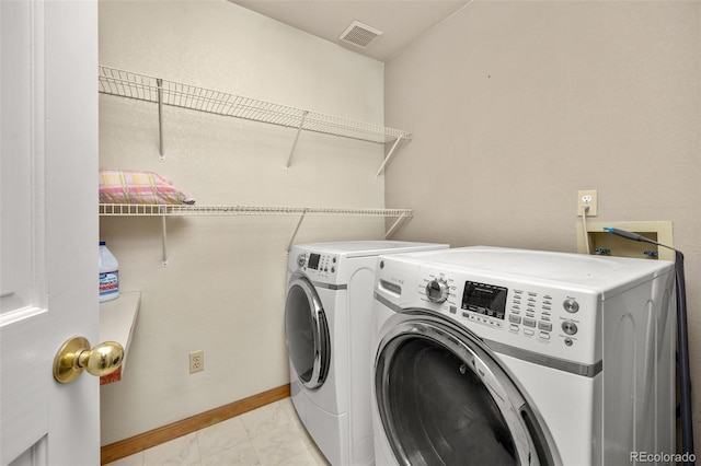 6868 Johnson St, Arvada, CO 80004 - laundry area featuring separate washer and dryer, baseboards, and light tile patterned floors