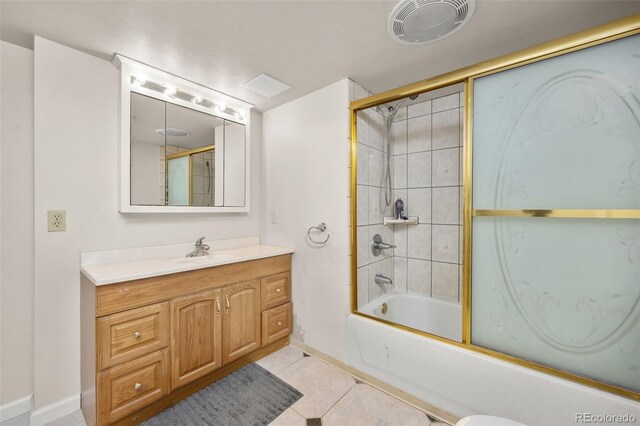 6868 Johnson St, Arvada, CO 80004 - bathroom featuring vanity, tile patterned flooring, baseboards, and enclosed tub / shower combo