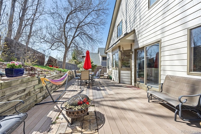 6868 Johnson St, Arvada, CO 80004 - wooden terrace with outdoor dining area and a fenced backyard