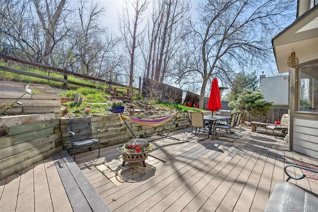 6868 Johnson St, Arvada, CO 80004 - wooden deck with outdoor dining space and a fenced backyard