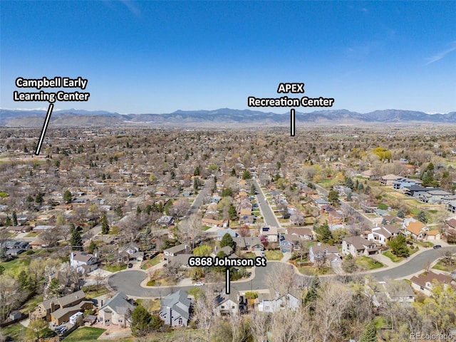 6868 Johnson St, Arvada, CO 80004 - aerial view of property's location with a mountainous background and nearby suburban area