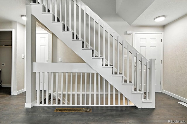 2976 S Parker Ct, Aurora, CO 80014 - staircase featuring wood finished floors and a textured wall