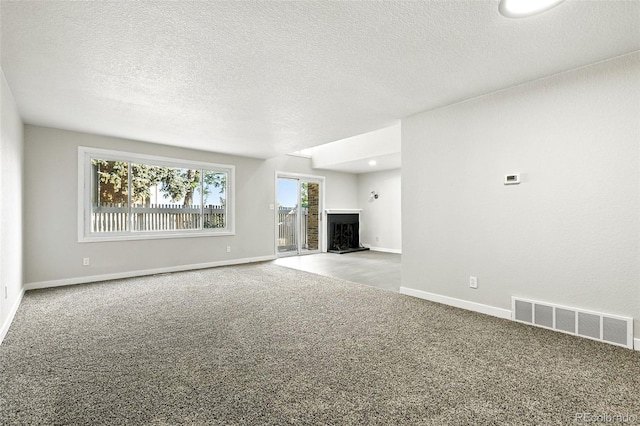 2976 S Parker Ct, Aurora, CO 80014 - unfurnished living room featuring carpet, a fireplace with raised hearth, and a textured ceiling