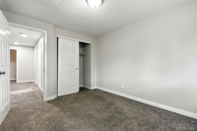 2976 S Parker Ct, Aurora, CO 80014 - unfurnished bedroom featuring dark colored carpet, a closet, and a textured ceiling