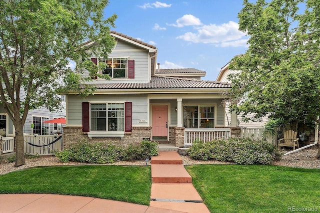 5107 Pasadena Way, Broomfield, CO 80023 - view of front of home featuring a tile roof, covered porch, and brick siding