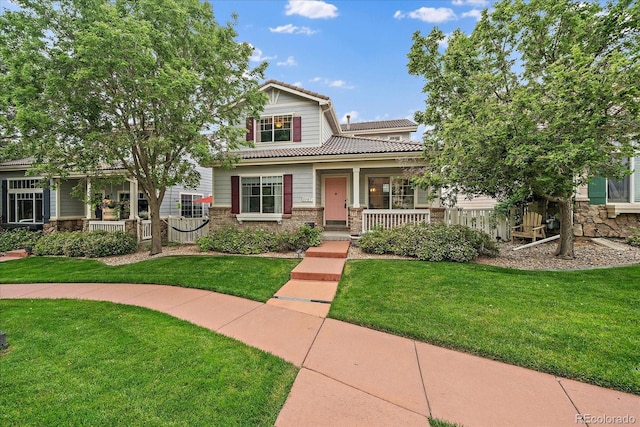 5107 Pasadena Way, Broomfield, CO 80023 - view of front of home with covered porch, a tile roof, stone siding, and a front yard