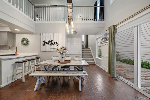 5107 Pasadena Way, Broomfield, CO 80023 - dining area with a high ceiling, wood finished floors, and stairway