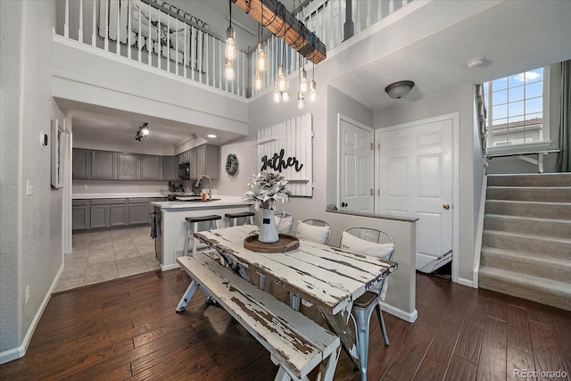 5107 Pasadena Way, Broomfield, CO 80023 - dining area featuring hardwood / wood-style floors, a high ceiling, and stairs