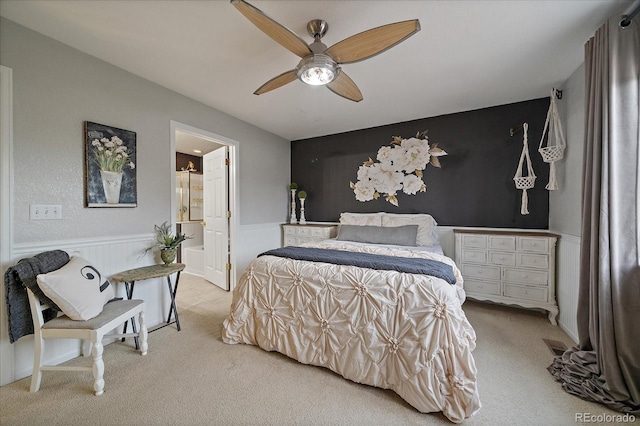 5107 Pasadena Way, Broomfield, CO 80023 - bedroom with carpet floors, wainscoting, ensuite bath, and ceiling fan