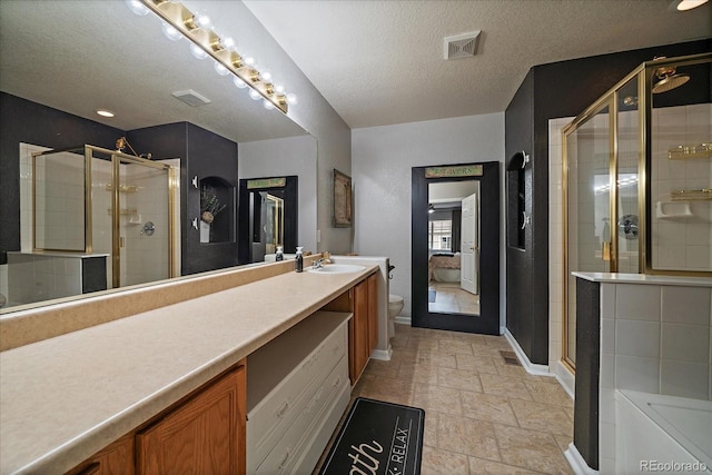 5107 Pasadena Way, Broomfield, CO 80023 - full bathroom with a textured ceiling, a stall shower, vanity, stone finish flooring, and a bath