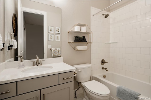 full bathroom with tiled shower / bath combo, vanity, and toilet