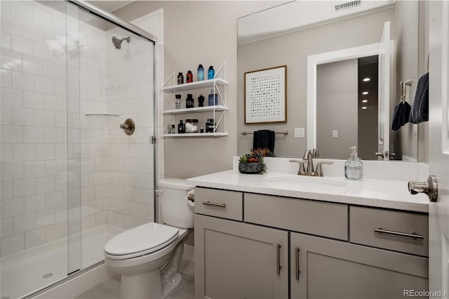 bathroom with vanity, walk in shower, and toilet