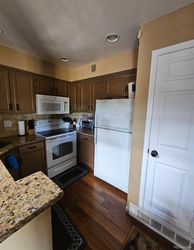 6711 S Ivy Way Unit B5, Centennial, CO 80112 - kitchen with white appliances, dark wood-style floors, recessed lighting, backsplash, and dark brown cabinets