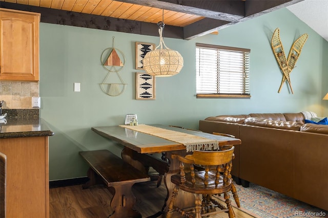 dining space featuring dark hardwood / wood-style flooring, wood ceiling, and beamed ceiling