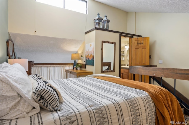 bedroom featuring a textured ceiling and connected bathroom