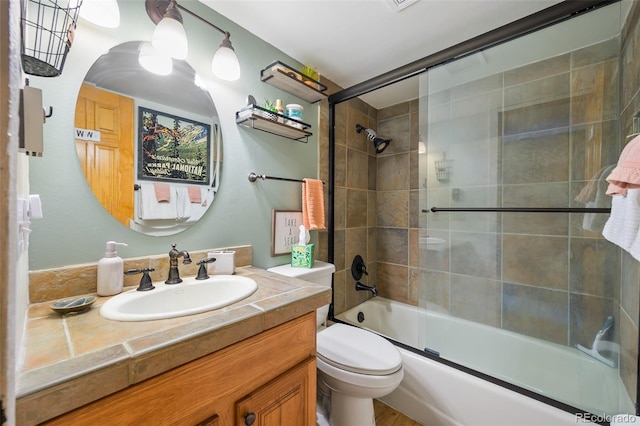 full bathroom with shower / bath combination with glass door, toilet, and vanity