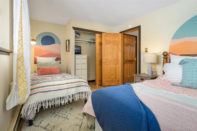 bedroom with a closet, a textured ceiling, and light hardwood / wood-style flooring