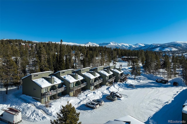 snowy aerial view featuring a mountain view