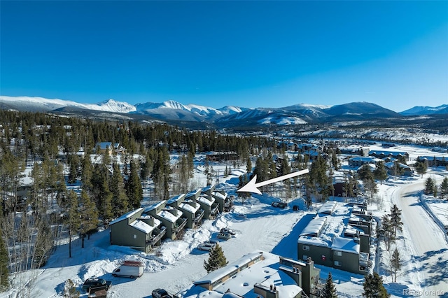 snowy aerial view with a mountain view