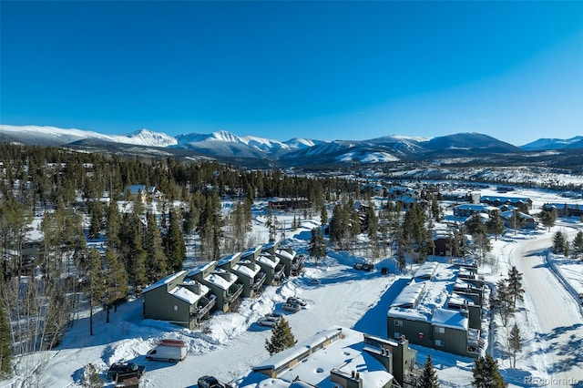 snowy aerial view with a mountain view