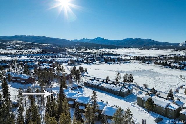 snowy aerial view featuring a mountain view