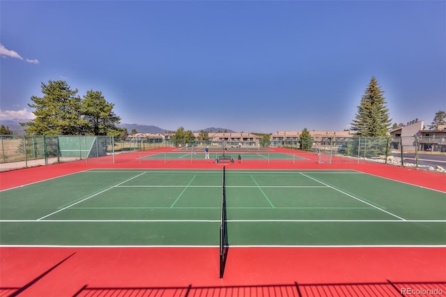 view of tennis court featuring basketball hoop