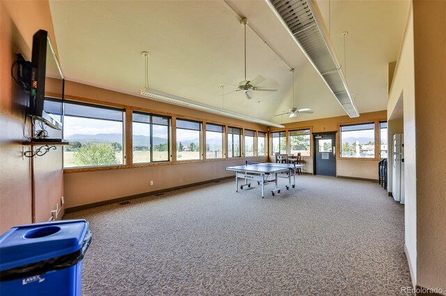 unfurnished sunroom with vaulted ceiling, ceiling fan, and a wealth of natural light