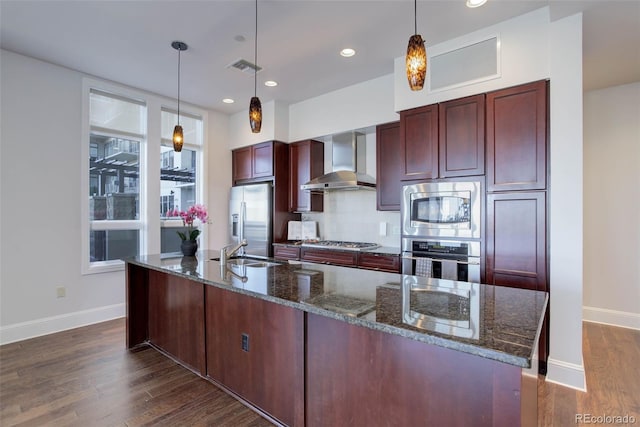 kitchen featuring a sink, wall chimney exhaust hood, stainless steel appliances, dark wood-style flooring, and baseboards