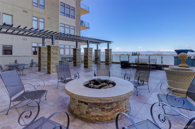 view of patio / terrace with a pergola and a fire pit