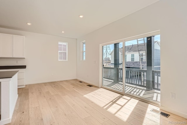 unfurnished living room featuring light wood-type flooring