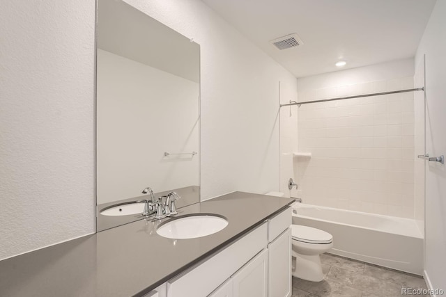 full bathroom with tiled shower / bath combo, vanity, and toilet