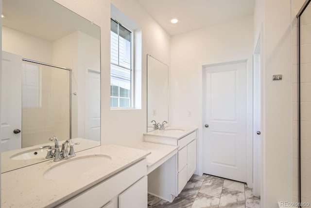 bathroom featuring an enclosed shower, vanity, and a healthy amount of sunlight