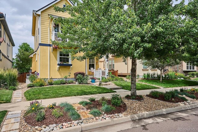 9311 E 5th Ave, Denver, CO 80230 - view of front of house featuring stucco siding and a front lawn
