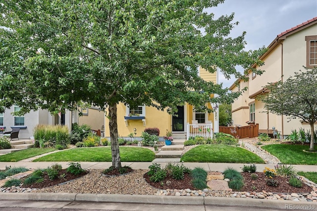 9311 E 5th Ave, Denver, CO 80230 - view of property hidden behind natural elements featuring stucco siding and a front yard